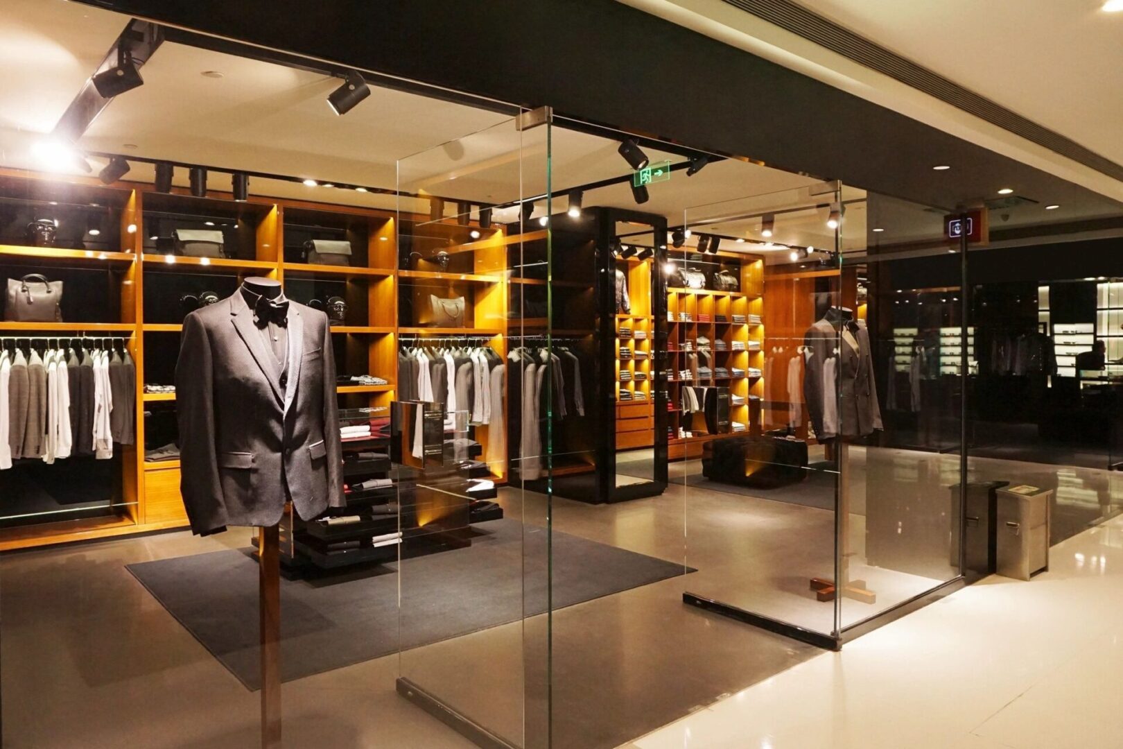 A store with several suits on display in it.