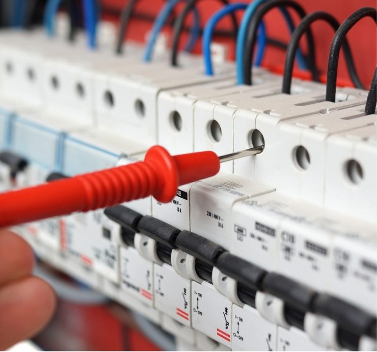 A person is working on an electrical panel.